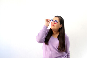 Latin adult woman with heart-shaped sunglasses shows enthusiasm for February and celebrate Valentine's Day of Love and Friendship with partner, friends and family
