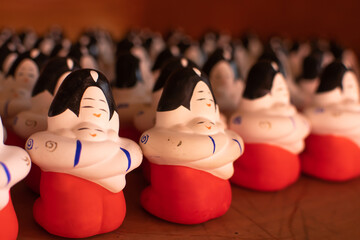 Clay dolls. Mother hold her baby whit her hands tightly. Both of them look so happy. Warmth and love. Angle from the left.