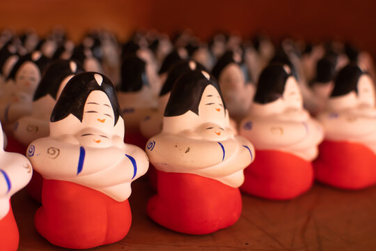 Clay dolls. Mother hold her baby whit her hands tightly. Both of them look so happy. Warmth and love. Angle from the left.