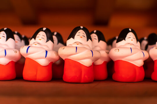 Clay dolls. Mother hold her baby whit her hands tightly. Both of them look so happy. Warmth and love. Front side.