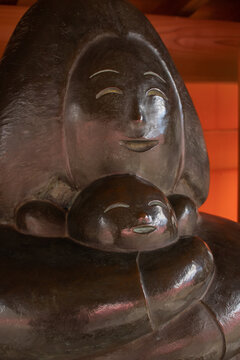Statue of casting finishing. Mother hold her baby whit her hands tightly. Both of them look so happy. Warmth and love. 