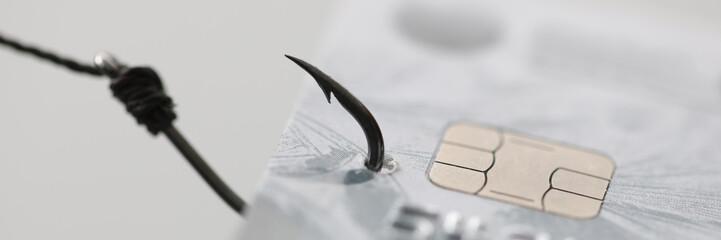 Bank plastic card hanging on fishing hook closeup