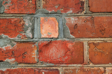 close up of old red brick wall with repaired part