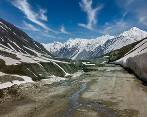 Difficult dusty road leading through the chilling heights of the Himalayan ranges from Kashmir to Leh.