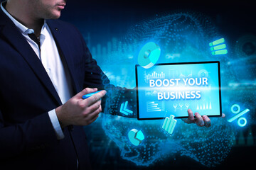 Business, Technology, Internet and network concept. Young businessman working on a virtual screen of the future and sees the inscription: Boost your business