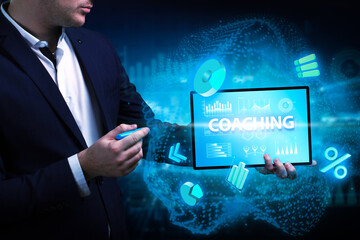 Business, Technology, Internet and network concept. Young businessman working on a virtual screen of the future and sees the inscription: Coaching