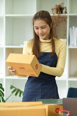 Fototapeta na wymiar Small business female owner, online seller prepare her delivery package