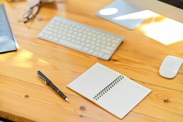 Modern office workspace with office supplies, stationery on wooden table.