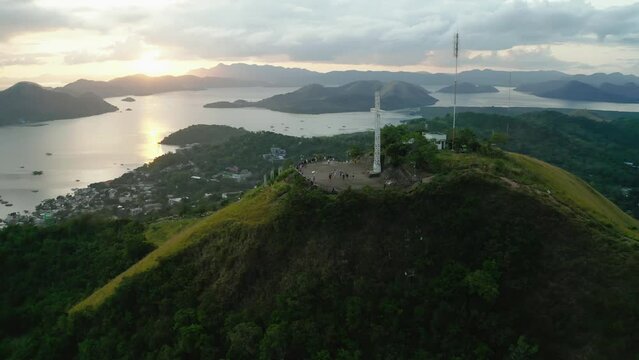 Aerial View Of White Cross On Mount Tapyas With Sunset Skies In Distance. Dolly Forward