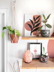 A cotton macrame is displayed next to shelves with various decor.