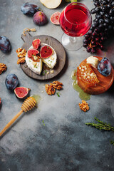 red wine with snacks bruschetta with pears, cottage cheese, figs, thyme, nuts and honey, camembert cheese