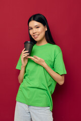 Portrait Asian beautiful young woman in a green t-shirt a glass of drink fun isolated background unaltered