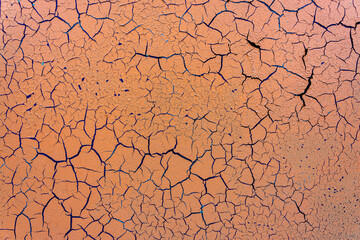 Cracked and damaged painted surface of a building or wall. Texture, aged paint background