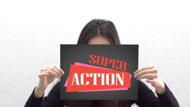 Conceptual message "Super Action" on canvas frame label hold by beautiful girl smiling at camera