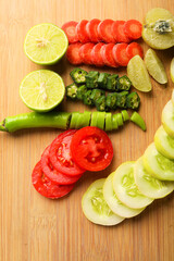 Helthy food concept : Raw vegetable slices on wooden board