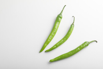 Fresh green chili on white background.