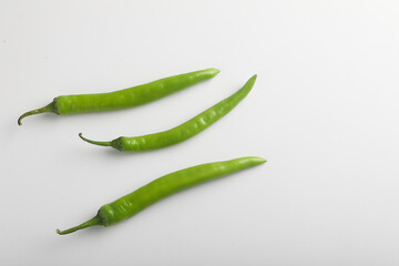 Fresh green chili on white background.