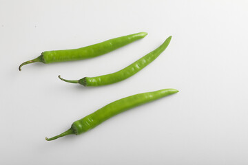 Fresh green chili on white background.