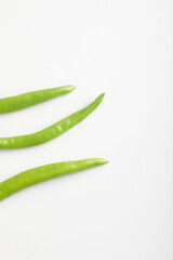 Fresh green chili on white background.