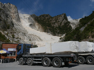 trucks for the transport of Carrara marble blocks with marble quarries on the mountains in the...