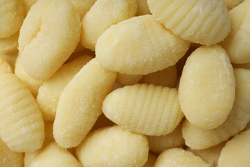 Concept of cooking with raw potato gnocchi, close up