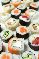 Concept of tasty food with sushi rolls on white background