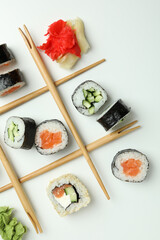 Concept of tasty food with sushi rolls on white background © Atlas