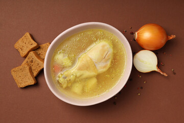 Concept of tasty food with chicken soup on brown background