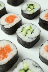 Concept of tasty food with sushi rolls on white background