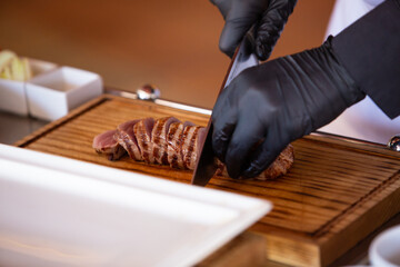 the chef prepares a beef steak