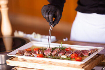 the chef prepares a beef steak