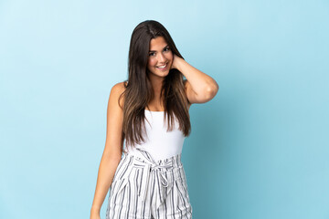 Young brazilian woman isolated on blue background laughing