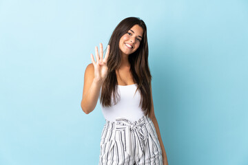 Fototapeta na wymiar Young brazilian woman isolated on blue background happy and counting four with fingers