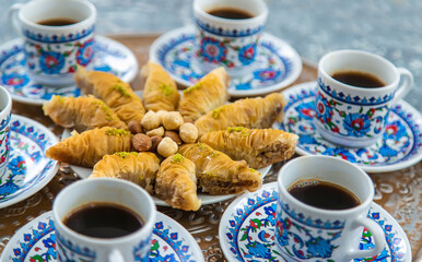 Turkish baklava and coffee on the table. Selective focus.