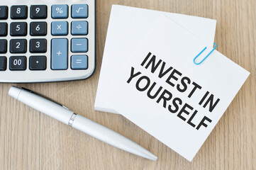 Business and finance concept, a business card with the inscription - Invest in Yourself