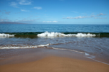 Fototapeta na wymiar Beach and tropical sea background. Concept of summer relaxation. Surf splashing tide.
