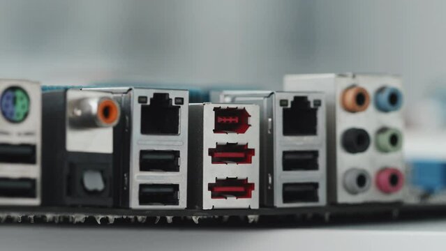 Close up tracking shot of output hubs with different computer ports for USB and audio cables