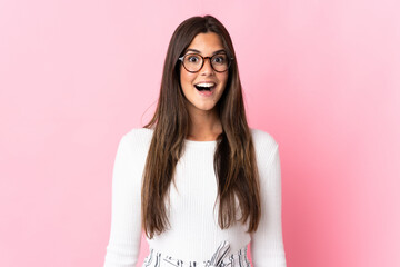 Young brazilian woman isolated on pink background with surprise facial expression