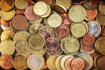 Coins shiny background, top view. Euros and cents