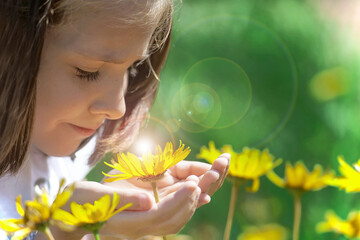 Yellow flower in the hands of child. World Environment Day. Earth day.