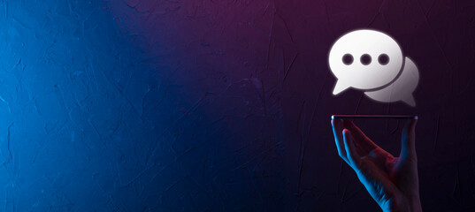 Businessman holding a message icon, bubble talk notification sign in his hands. Chat icon, sms icon, comments icon, speech bubbles