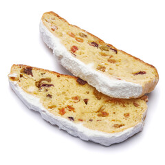 Slices of Traditional Christmas stollen cake with marzipan and dried fruit isolated on white background