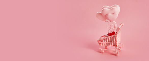 Heart shaped baloons in the pink shopping cart on a pink background. Season sale, spring shoping concept. Valentines day.