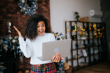 Nice attractive lovely overjoyed crazy woman holding in hands laptop, goal achievement