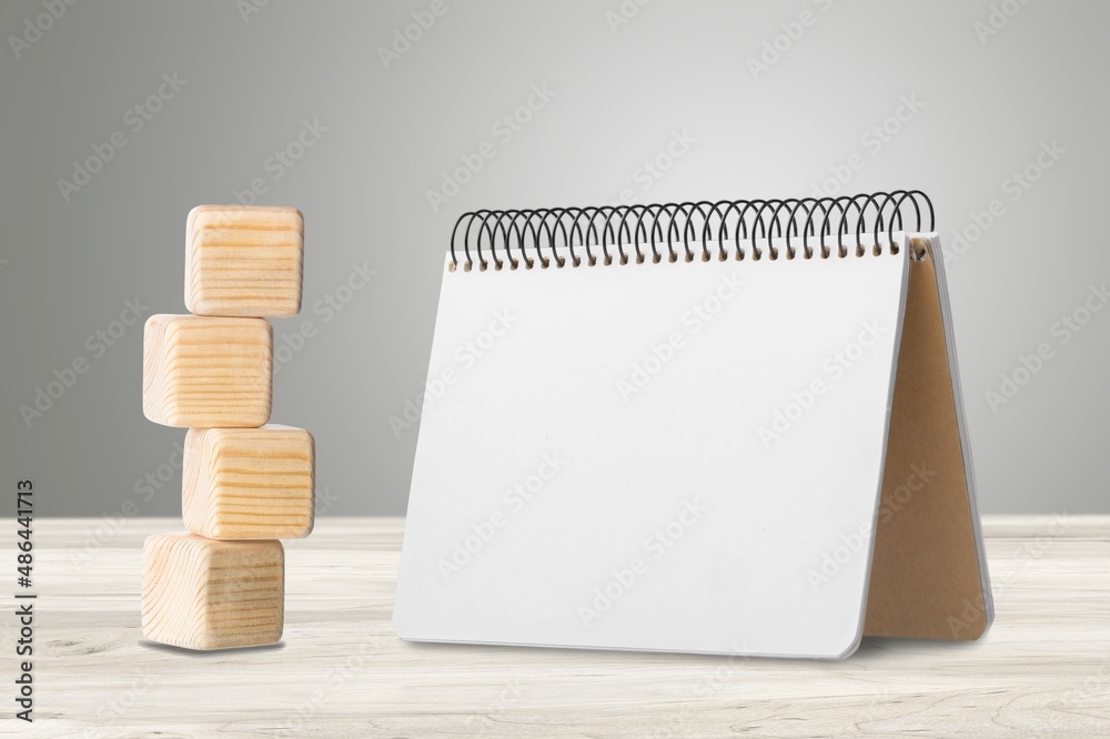 Sticker 2022 mockup notepad and cubes wooden on table background, plans for New Year 2022