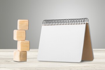 2022 mockup notepad and cubes wooden on table background, plans for New Year 2022