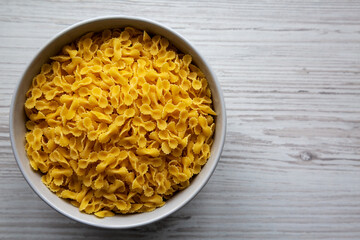 Healthy Dry Farfalline Pasta in a Bowl, top view. Flat lay, overhead, from above. Space for text.