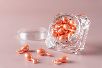 Single-dose serum capsules with active ingredients in a crystal shape container. Skin care and beauty products.