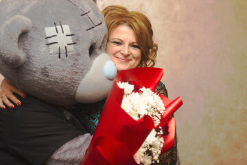A beautiful blonde accepts congratulations from an animator bear. She is happy