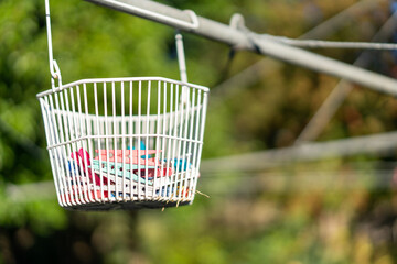 Traditional hills hoist washing line in an Australian backyard, with clothes pegs on it